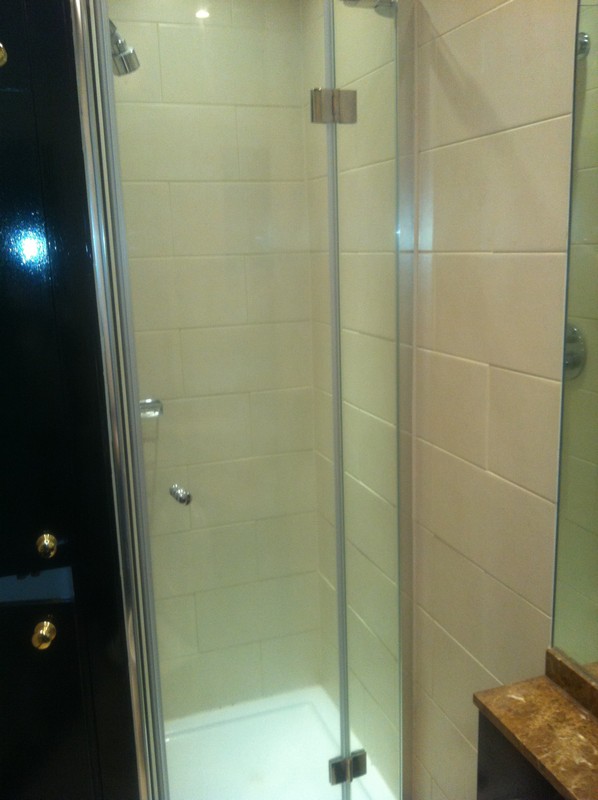 Frameless glass shower enclosure with chrome fittings in Clapham