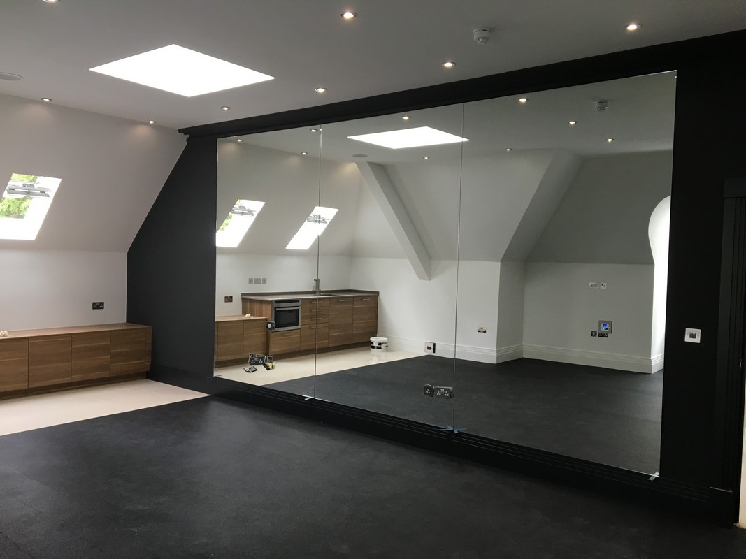 Frameless glass wall dividing loft conversion in Clapham